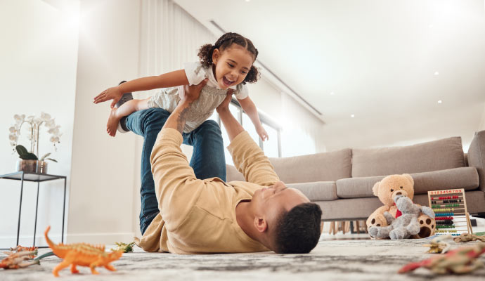 Parent playing with child in a clean and cozy living room