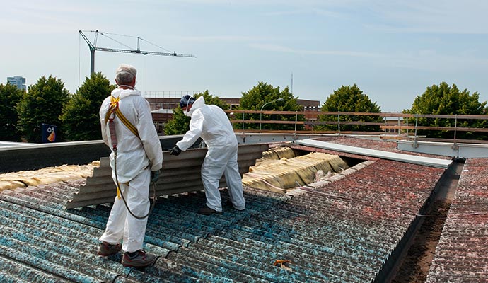 Professional team removing asbestos roofing sheets