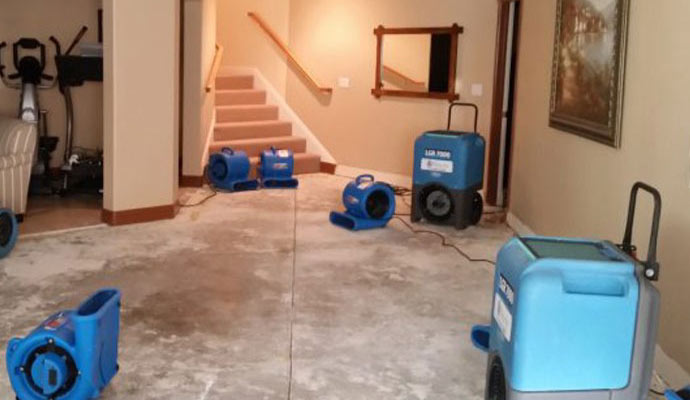 Basement undergoing flood restoration with equipment