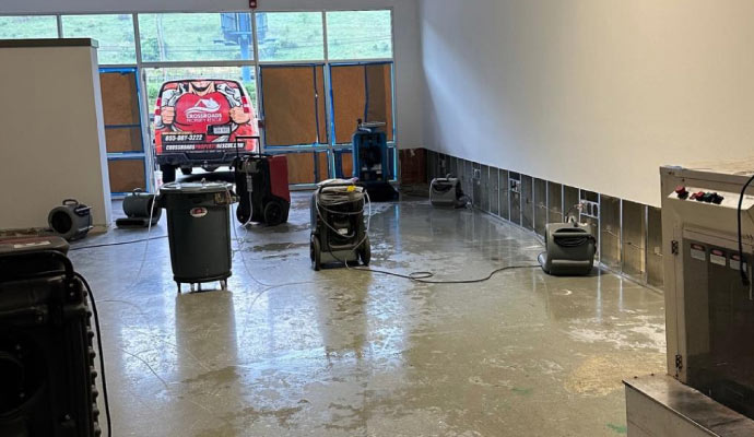 Room undergoing flood cleanup with equipment