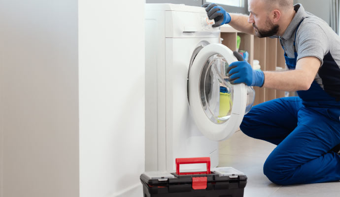 Professional inspecting a washing machine